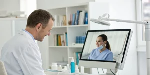 Dentist attending an advanced online dental grafting course from their office.