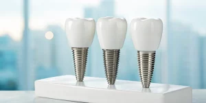 Three types of dental implants with their titanium posts and ceramic crowns.