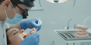 Dentist hands performing implant overdenture procedure in a modern clinical operatory