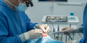 Oral surgeon performing advanced ridge augmentation in a modern dental operatory