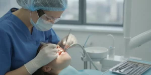 Dental professional performing atraumatic tooth extraction in a modern clinical operatory