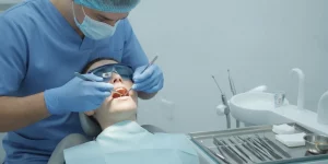 Dentist performing a surgical tooth extraction in a modern dental operatory.